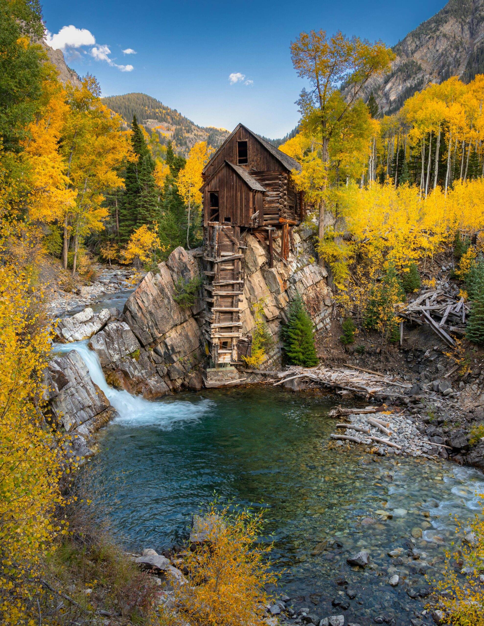 Stunning view of Crystal Mill surrounded by vibrant autumn foliage in the Rocky Mountains.